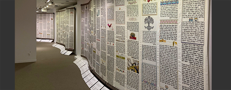 The panels meander through 10 galleries, suggesting Torah's scroll form and developing narrative.